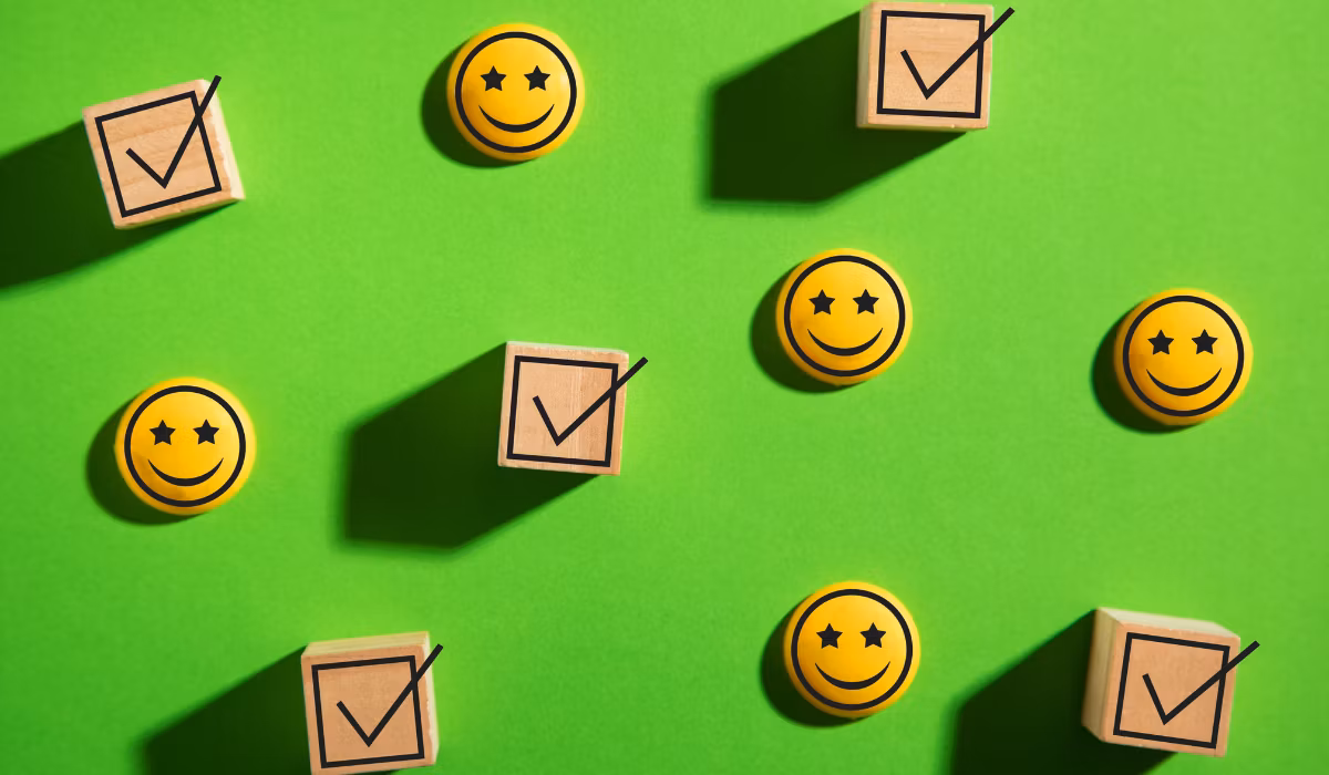 Smiley faces and checkmarks spaced evenly on a green background